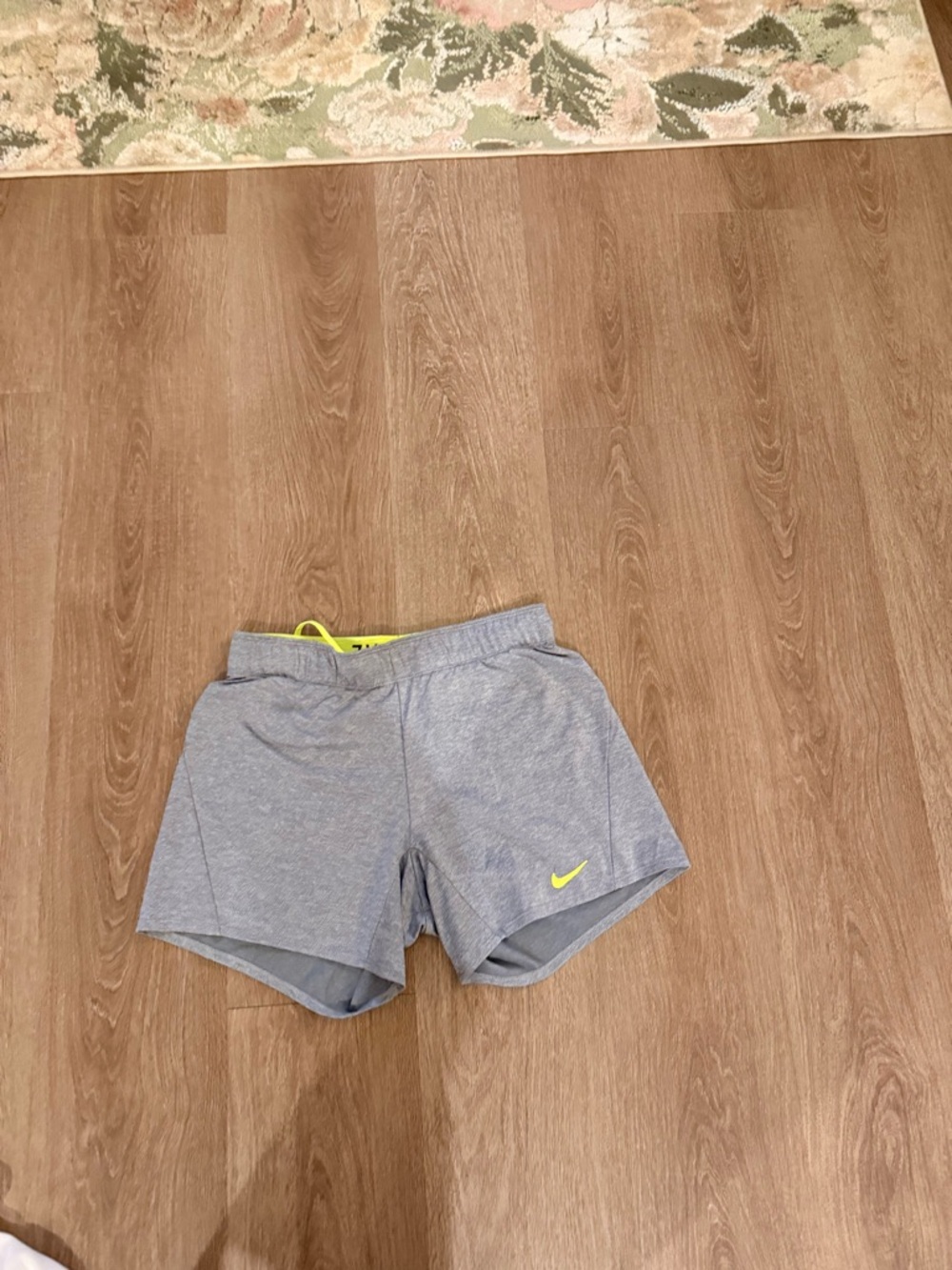 Nike Women's Light Gray Athletic Shorts with Yellow Swoosh